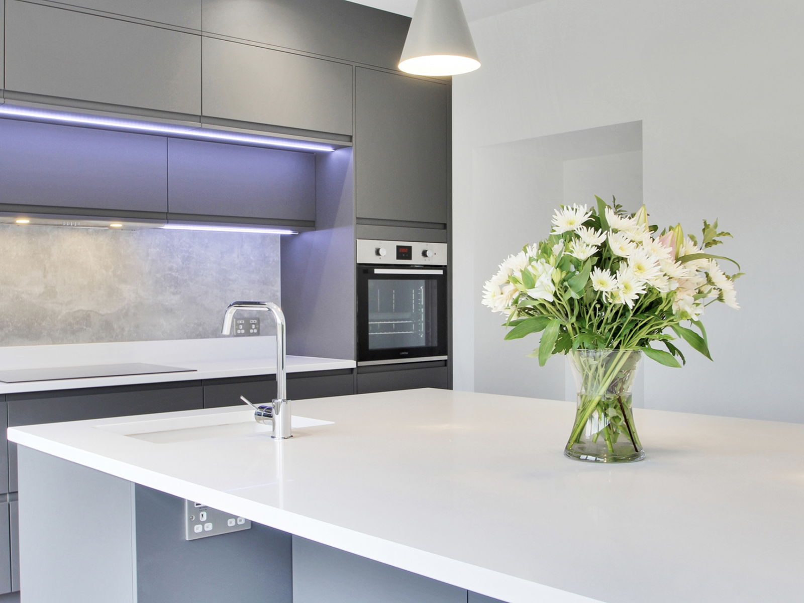 A grey handleless kitchen with an island, installed as part of a full chalet conversion
