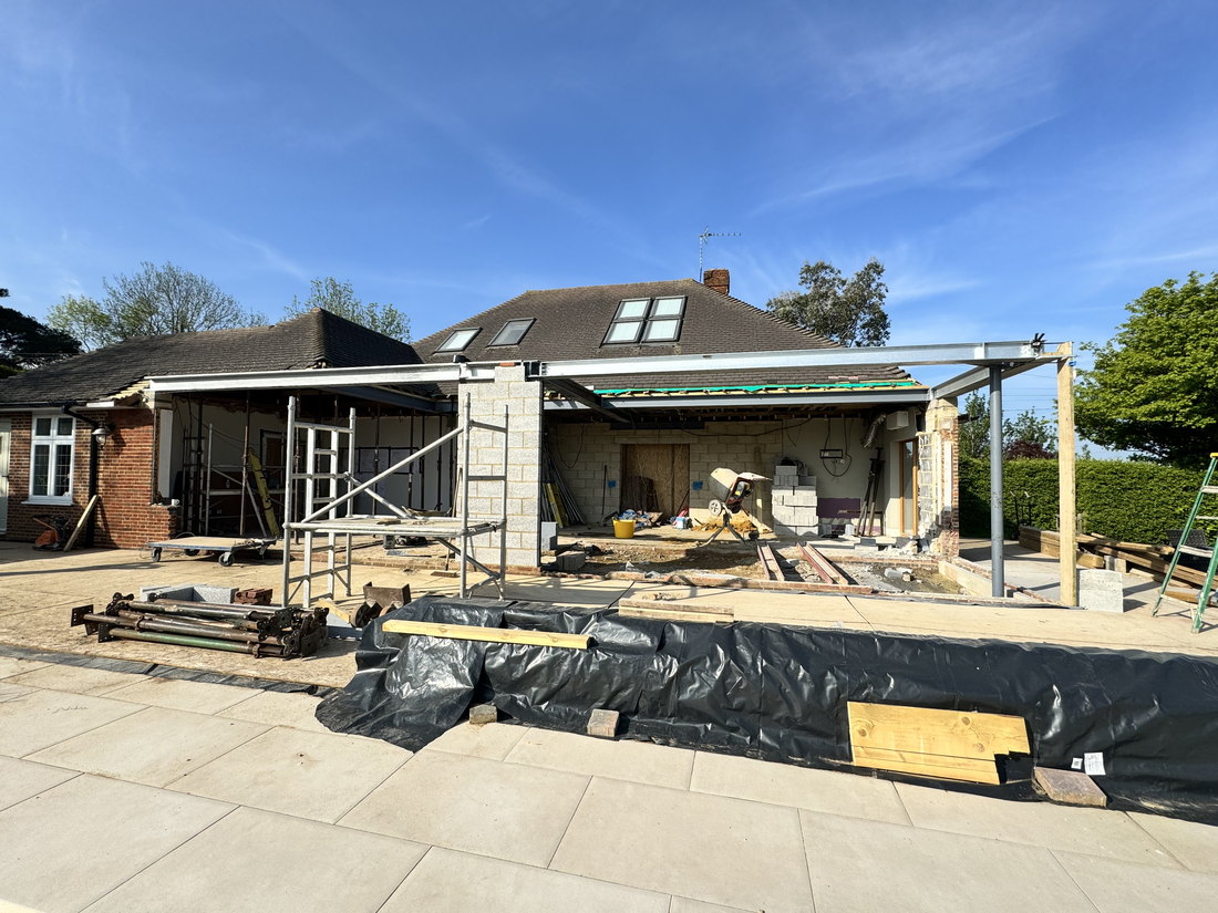 The extension under construction, with the steel frame erected across the back of the house, the original rear wall removed and blockwork going up, by LD&C Homes