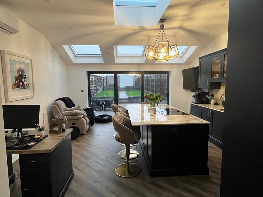 The finished ground floor looking through the open plan kitchen to the seating area and bifold doors onto the garden, by LD&C Homes