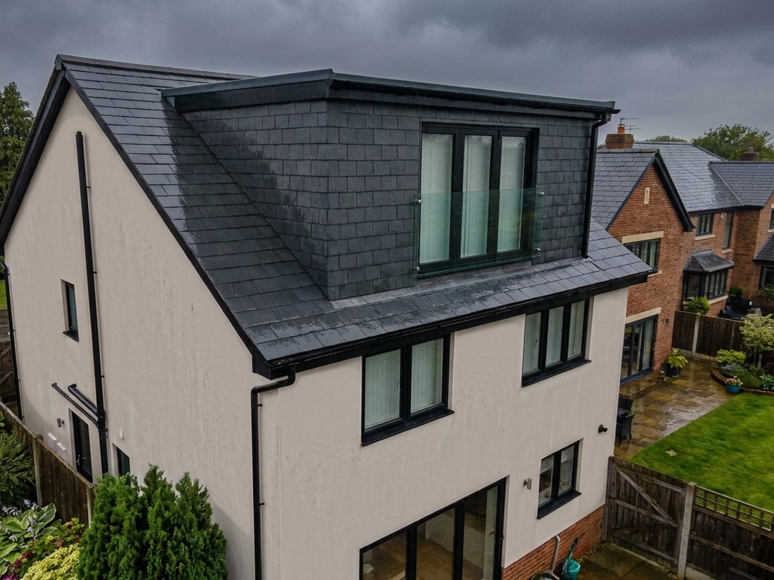 A hip to gable loft conversion on a semi detached house, with the hipped end rebuilt square and a new window in the new gable, built by LD&C Homes